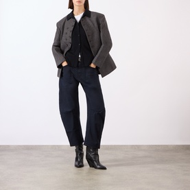 Model wearing Nili Lotan navy cotton barrel-leg trousers, styled with a grey cropped jacket and black ankle boots.