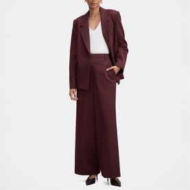 Model wearing Forever New berry wide-leg trousers and matching oversized blazer, styled with a white V-neck top.