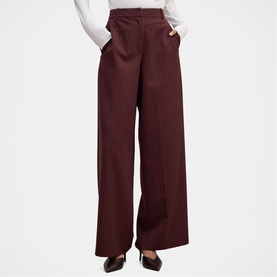 Model wearing Forever New berry pinstripe wide-leg high-waist trousers, styled with a white top and black heels.