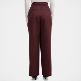 Model wearing Forever New berry ribbed wide-leg trousers, rear view, styled with a white long-sleeve top.