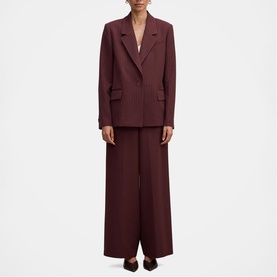 Model wearing Forever New berry wide-leg trousers styled with matching berry blazer, creating a coordinated suit look.