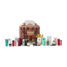 Rituals Classic Advent Calendar, house-shaped tin with festive design, displayed with 24 beauty miniatures arranged around it