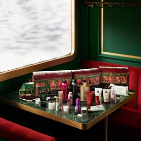 Rituals Premium Advent Calendar featuring multiple beauty products including body care, fragrance and home items on a coral backdrop