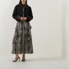 Model wearing Rixo London black viscose jacket with brown faux fur collar and cuffs, styled with leopard print midi skirt and black heeled sandals.