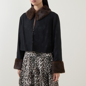 Model wearing Rixo London black viscose jacket with brown faux fur collar and cuffs, styled with leopard print skirt.