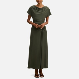 Model wearing Forever New Thyme Green maxi dress with cowl neck, short sleeves, ruched waist detail and wrap-style skirt, styled with brown sandals.