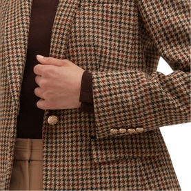 Model wearing Hobbs brown multi houndstooth blazer with gold buttons, styled with brown roll-neck and camel trousers