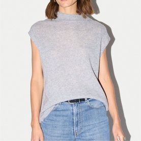 Model wearing Jigsaw Grey Melange sleeveless mock-neck knit top, styled with light blue denim jeans.