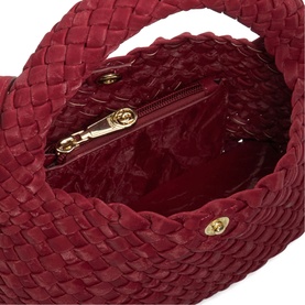 Dune berry woven bag interior showing red fabric lining, zip pocket, and gold-tone hardware detail.