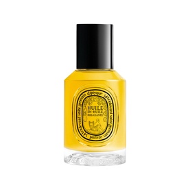 Diptyque Huile de Minuit Body Oil in amber glass bottle with gold circular label and black cap