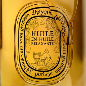Diptyque Huile en Huile Relaxante body oil in amber glass bottle with oval label and botanical illustration detail