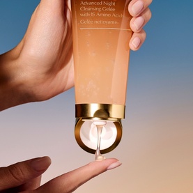 Est&eacute;e Lauder Advanced Night Repair Discovery Skincare Set; orange cleansing gel tube with gold cap being squeezed, dispensing clear gel