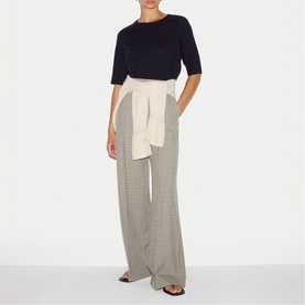 Model wearing Jigsaw navy short sleeve top with houndstooth wide-leg trousers and cream tie belt, styled with flat sandals.