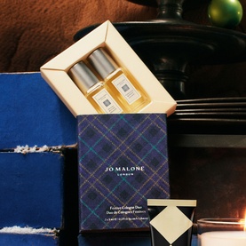 Jo Malone London Festive Cologne Duo gift set in navy tartan box with two miniature cologne bottles displayed inside cream inner tray
