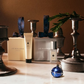 Jo Malone Wood Sage & Sea Salt Stocking Filler Gift Set with hand cream and cologne, styled with festive candelabras and blue bauble