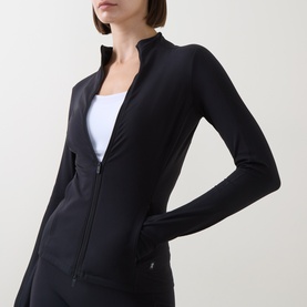 Model wearing On Running black zip-up jacket with stand collar, styled with white top and black bottoms.