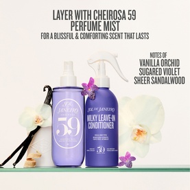 Sol De Janeiro Milky Leave-In Conditioner in purple bottle styled with Cheirosa 59 Perfume Mist spray, orchid and vanilla props