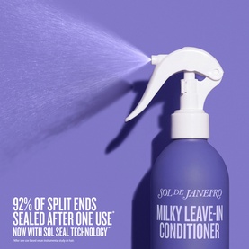 Sol De Janeiro Milky Leave-In Conditioner spray bottle dispensing a fine mist, with split ends claim text visible on pack.