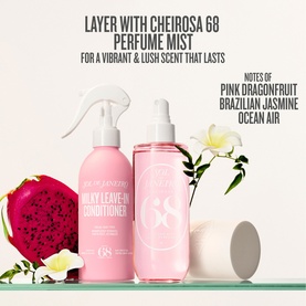 Sol De Janeiro Milky Leave-In Conditioner in pink bottle styled with Cheirosa 68 Perfume Mist spray and dragon fruit florals