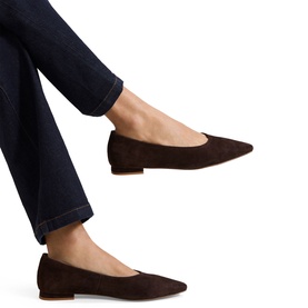 Model wearing Phase Eight brown suede pointed-toe flat ballerina shoes, styled with dark navy wide-leg jeans