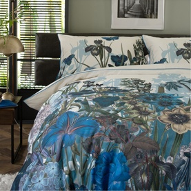 The Lyndon Company blue floral botanical duvet set styled on a double bed, featuring bold blue, teal and cream flower print