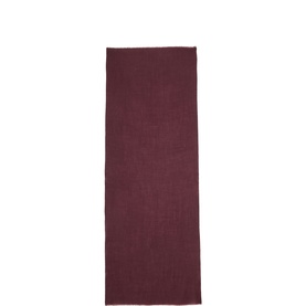 Jigsaw burgundy woven scarf with frayed edges, laid flat in a long rectangular shape.