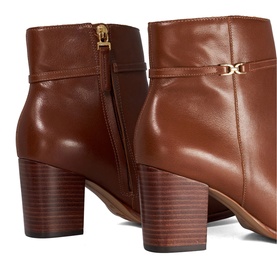 Tan leather ankle boots with gold logo hardware, zip detail, and stacked block heel shown in close-up rear and side view