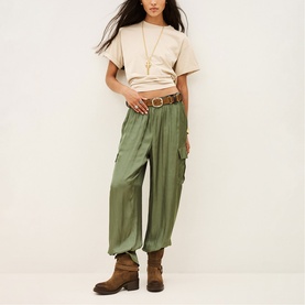 Model wearing Bash green cargo-style wide-leg trousers with a crop tee, brown belt and ankle boots.