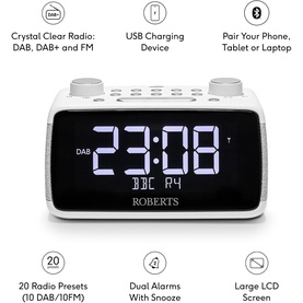 Roberts Ortus 4 FM Dual Alarm Clock Radio in white, showing large LCD display, DAB/FM radio, USB charging port, and Bluetooth connectivity icons