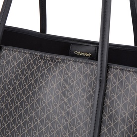 Calvin Klein Emblem Medium Work Tote Bag in black monogram print, gold logo plaque, dual black shoulder straps visible at top