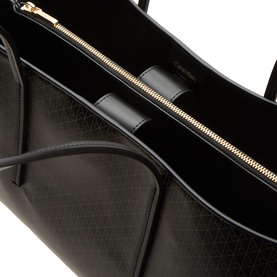 Calvin Klein Emblem Medium Work Tote Bag in black, showing interior with gold-tone zip, three compartments and monogram-print lining