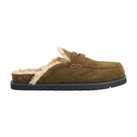 Tan suede mule slipper with cream shearling lining, penny loafer strap detail, and dark rubber sole