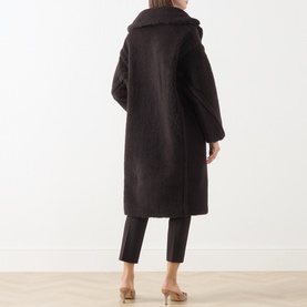 Model wearing Max Mara Main dark brown alpaca wool blend long coat, back view, styled with cropped trousers and nude heels
