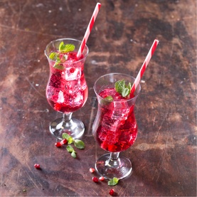 Ravenhead Set of Two Entertain Cocktail Glasses filled with red berry drinks, ice, mint garnish and striped straws, on rustic surface.