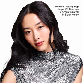 Model with Clinique Lash Definition & Black Honey Lip Makeup Gift Set; wearing mascara and Black Honey lipstick, silver sequin top