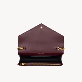 Saint Laurent hot wine leather envelope bag, open view showing interior compartment and gold-tone chain strap detail