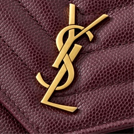 Saint Laurent bag in Hot Wine textured leather with quilted chevron stitching and gold-tone YSL monogram hardware, close-up detail