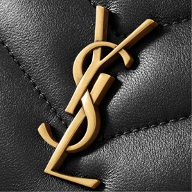 Saint Laurent black quilted leather bag close-up showing gold-tone YSL monogram hardware detail