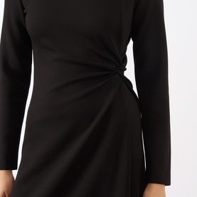 Model wearing MeiMeij nero dress with long sleeves and twist knot detail at the waist, flared skirt silhouette.