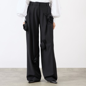 Model wearing MeiMeij Nero wide-leg trousers with 3D satin rose appliqu&eacute;s, styled with a white puff-sleeve blouse.
