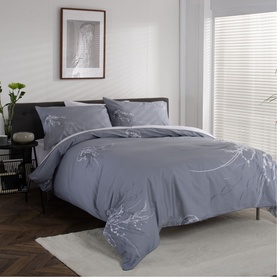 The Lyndon Company Duvet Set in grey with white floral crane embroidery, styled on a double bed with matching pillowcases