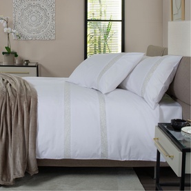 The Lyndon Company Duvet Set in white with decorative lace trim band, styled on a double bed with matching pillowcases