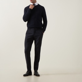 Model wearing Tiger of Sweden Connor RWS Merino Sweater in Light Ink, crew neck fine knit, styled with white shirt and dark tailored trousers.