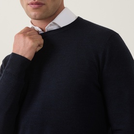 Model wearing Tiger of Sweden Connor RWS Merino Sweater in Light Ink, crew neck fine knit, styled with a white shirt underneath.