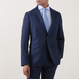 Model wearing Tiger of Sweden suit jacket in sea blue wool, styled with matching trousers and light blue tie