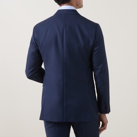 Model wearing Tiger of Sweden suit jacket in Sea blue, shown from behind, styled with matching trousers and light blue shirt