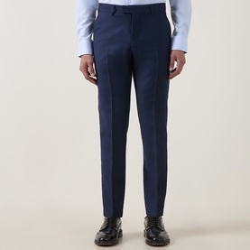 Model wearing Tiger of Sweden Sea suit trousers with light blue shirt, styled with black leather oxford shoes.