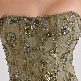 Model wearing House of CB olive strapless corset with gold and silver floral beaded and sequin embroidery detailing