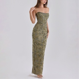 Model wearing House of CB olive strapless maxi dress with floral appliqu&eacute; detailing and fitted silhouette
