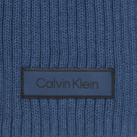 Calvin Klein dark denim blue ribbed cotton scarf, close-up showing woven label detail and chunky knit texture